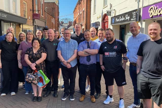 Some of Melton Mowbray's traders who have built a community with their radios to make the town centre safer
