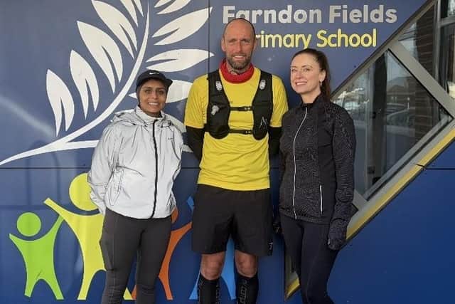 Liam Collins pictured at Farndon Fields School during his 90-mile challenge with Discovery Trust director of specialist provision, Rosalind Hopkins (right)