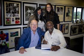 Derek Redmond (right) signs his new contract alongside Champions (UK)( plc CEO John Hayes