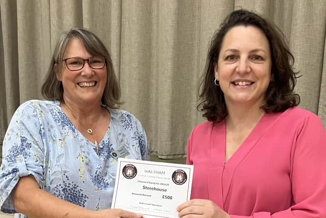Tracy Hunsley, from the Waltham Scottish Dancing Group (left) presents a cheque for £500 to Storehouse manager, Natalie Stathakis