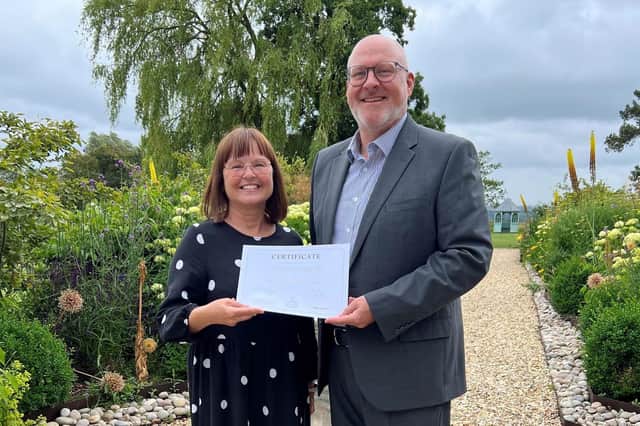 Emmaus director, Dawn Wright, receives a cheque from Hugh Wilson, Ragdale Hall Spa's managing director