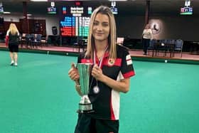 Izzy Pymm shows off the BIIBC Women's U25 International Championship trophy.