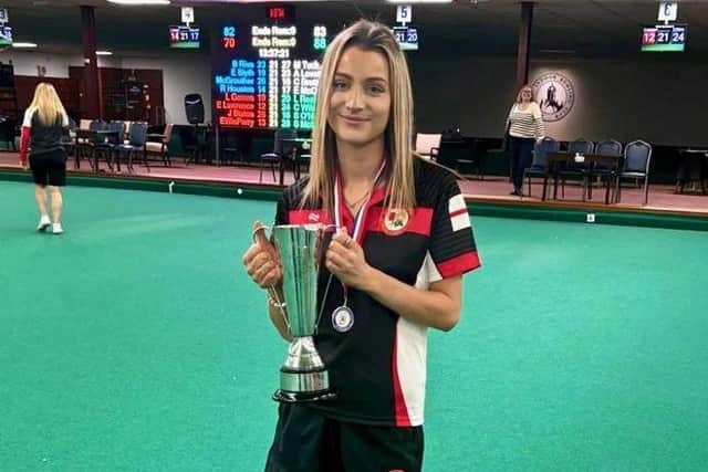Izzy Pymm shows off the BIIBC Women's U25 International Championship trophy.