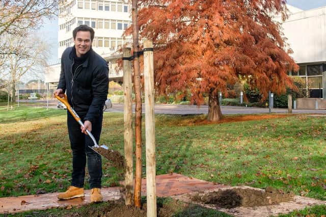 Councillor Blake Pain plants the 100,000th tree in Leicestershire outside County Hall