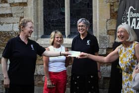 A cheque is presented by Gillian Geddes, artistic director of Burrough Jazz, to Sue Measey, PCC Treasurer, and other members at St Mary the Virgin, Burrough on the Hill