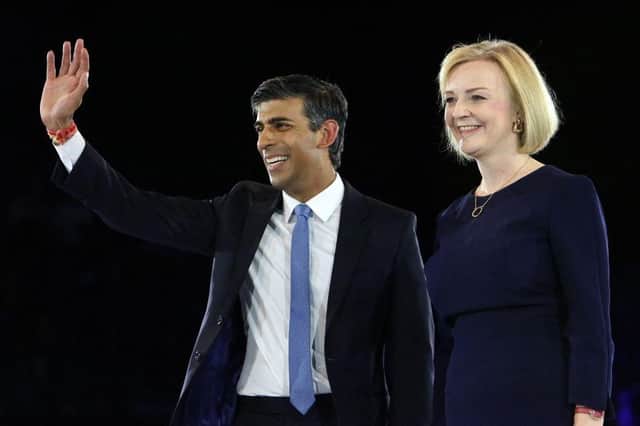 Rishi Sunak, Britain's former Chancellor of the Exchequerm (L) and Britain's Foreign Secretary Liz Truss, stand together on stage during the final Conservative Party Hustings event at Wembley Arena, in London, on August 31, 2022. (Photo by Susannah Ireland / AFP) (Photo by SUSANNAH IRELAND/AFP via Getty Images)