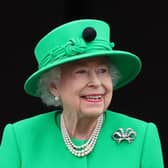 Britain's Queen Elizabeth II smiles to the crowd from Buckingham Palace balcony at the end of the Platinum Pageant in London on June 5, 2022 as part of Queen Elizabeth II's platinum jubilee celebrations. - The curtain comes down on four days of momentous nationwide celebrations to honour Queen Elizabeth II's historic Platinum Jubilee with a day-long pageant lauding the 96-year-old monarch's record seven decades on the throne. (Photo by Chris Jackson / POOL / AFP) (Photo by CHRIS JACKSON/POOL/AFP via Getty Images)
