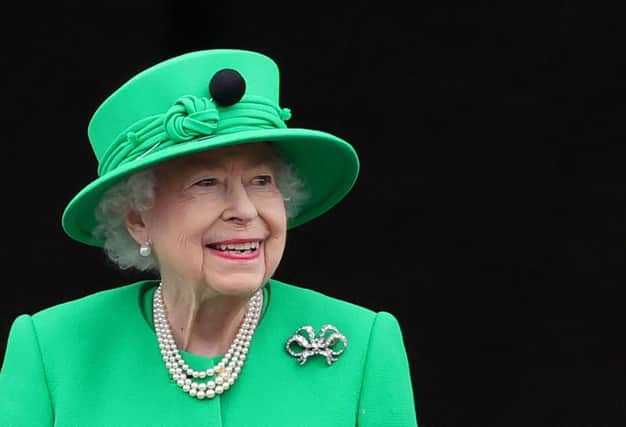 Britain's Queen Elizabeth II smiles to the crowd from Buckingham Palace balcony at the end of the Platinum Pageant in London on June 5, 2022 as part of Queen Elizabeth II's platinum jubilee celebrations. - The curtain comes down on four days of momentous nationwide celebrations to honour Queen Elizabeth II's historic Platinum Jubilee with a day-long pageant lauding the 96-year-old monarch's record seven decades on the throne. (Photo by Chris Jackson / POOL / AFP) (Photo by CHRIS JACKSON/POOL/AFP via Getty Images)