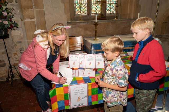 Anna Harrison signs some of her fundraising books for the church PHOTO Shelley Costello