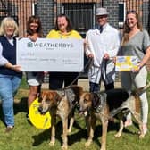 Members of the Quorn Hunt present a fundraising cheque to representatives of the Derbyshire, Leicestershire and Rutland Air Ambulance