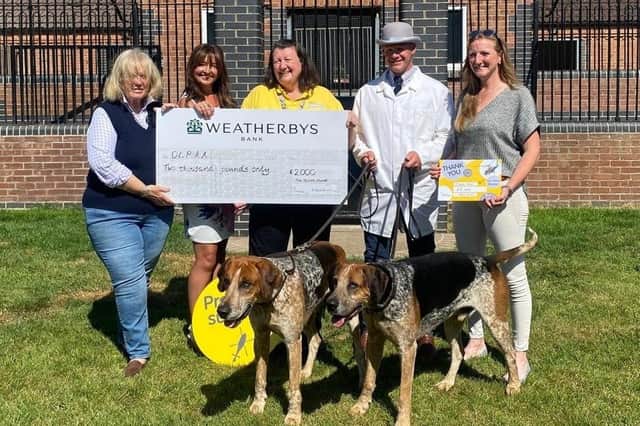 Members of the Quorn Hunt present a fundraising cheque to representatives of the Derbyshire, Leicestershire and Rutland Air Ambulance