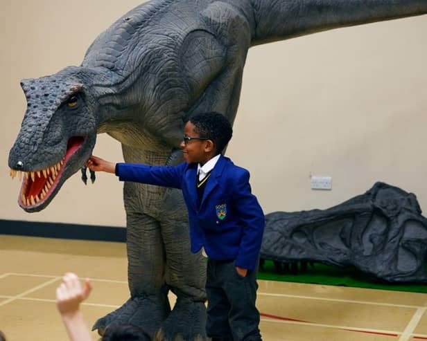 Reggie the animatronic T-Rex with a pupil at one of the Giant Journeys workshops.
