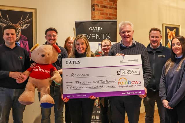 Director Nigel Gates and team members present a cheque to Maria Thompson, community fundraiser at Rainbows