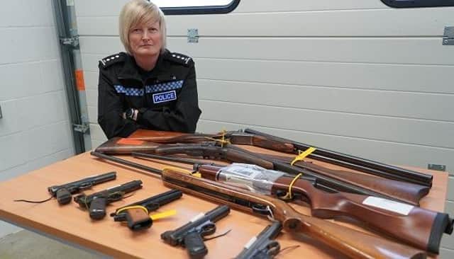 Chief Inspector Cara Guest-Moore, Specialist Support, Tactical Dogs and Firearms for Leicestershire Police, with some of the 74 firearms and components handed over to county policing teams for a national firearms surrender