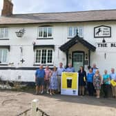 Members of the community campaign team for The Black Horse at Grimston pictured earlier this year with MP Alicia Kearns