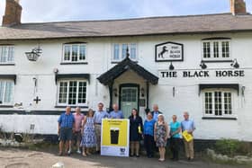 Members of the community campaign team for The Black Horse at Grimston pictured earlier this year with MP Alicia Kearns