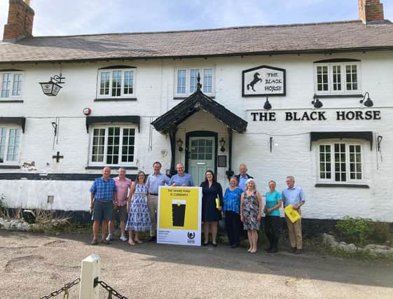 Members of the community campaign team for The Black Horse at Grimston pictured earlier this year with MP Alicia Kearns
