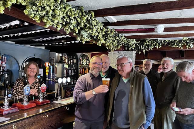 Jon Lovesay prepares down the first pint pulled at The Bell as it reopened