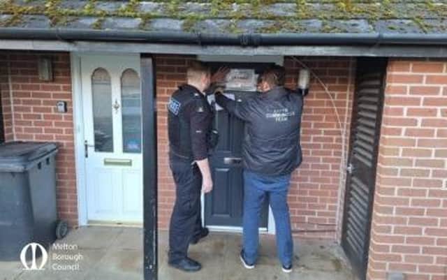 The property on Mayfield Street is pictured being closed by police and council officials