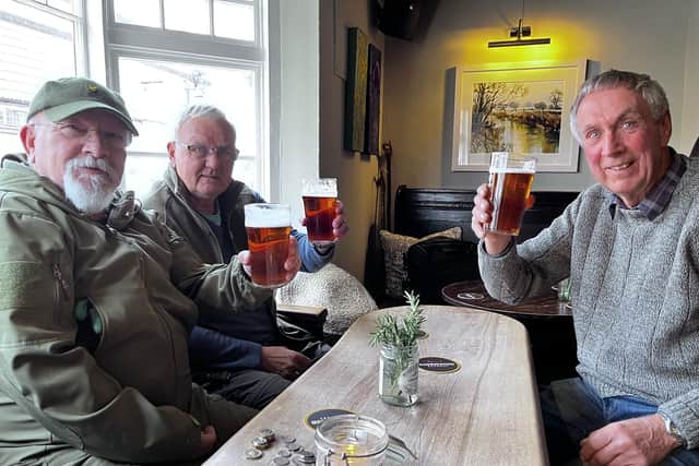 Regulars enjoy a pint at the reopened The Bell