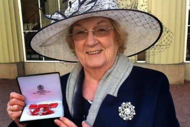 Pam Posnett shows off her MBE after being presented with it in 2017 at Buckingham Palace