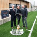 Melton Town assistant manager Paul Anderson (centre) with representatives from Bellway.