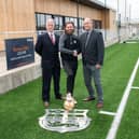 Melton Town assistant manager Paul Anderson (centre) with representatives from Bellway.