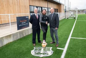 Melton Town assistant manager Paul Anderson (centre) with representatives from Bellway.