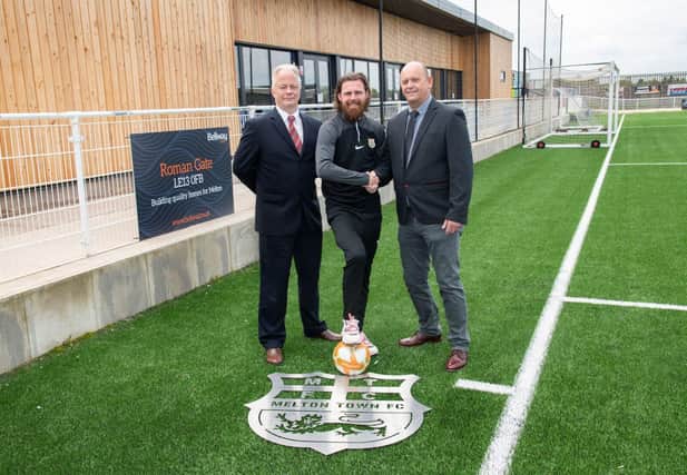 Melton Town assistant manager Paul Anderson (centre) with representatives from Bellway.