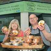 Phil and Kath Walmsley pictured outside the King Street shop they had in Melton for a short period
