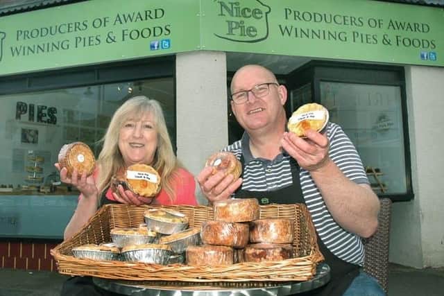 Phil and Kath Walmsley pictured outside the King Street shop they had in Melton for a short period