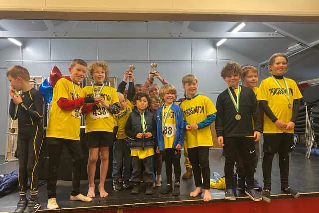 Pupils from Thrussington Primary School celebrating winning one of the team prizes at the fun run