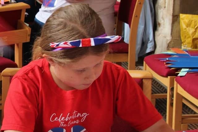 A little enjoys an art session at a royal-themed activities morning at Melton's St Mary's Church
PHOTO PHIL BALDING