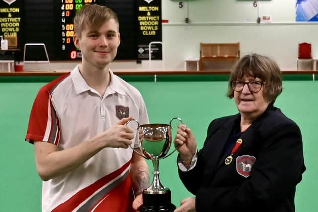 Paul Warrington receives his U25s county title trophy.