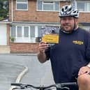 Darren Atwood takes a break from training for his cycling challenge to show off some leaflets for the charity he is supporting, Unlock Your You