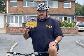 Darren Atwood takes a break from training for his cycling challenge to show off some leaflets for the charity he is supporting, Unlock Your You