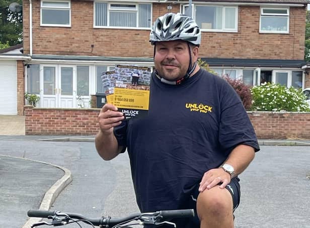Darren Atwood takes a break from training for his cycling challenge to show off some leaflets for the charity he is supporting, Unlock Your You