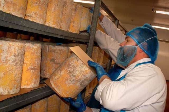 Staff inspect a new batch of Stilton at Long Clawson Dairy