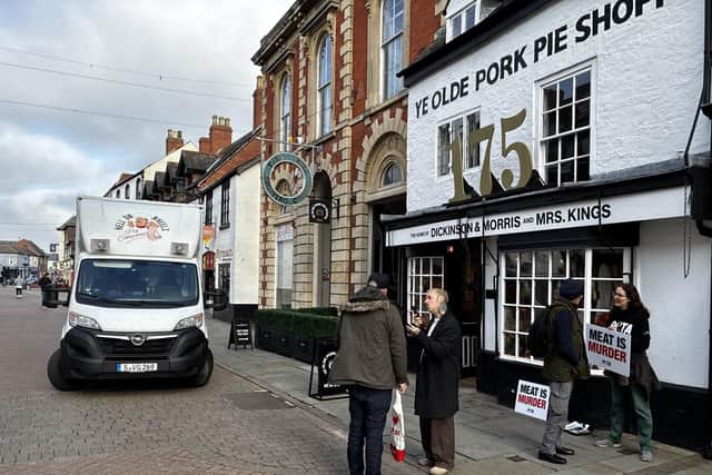 PETA campaigners outside Ye Olde Pork Pie Shoppe