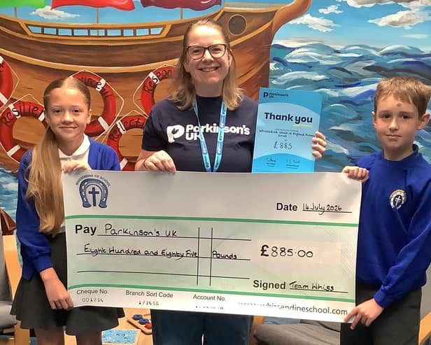 Young Governors present a cheque to Katie Thomas (Parkinson's UK) from their fundraising