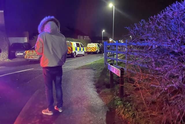 A resident watches the police stand-off in Melton last night
Photo George Icke