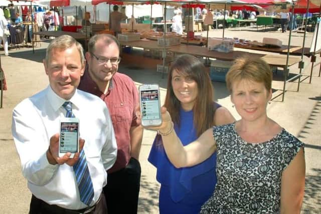 Shelagh Core pictured in 2018 with town centre colleagues showing off the new town centre app