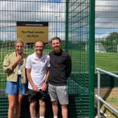 Long-serving John Ferneley College teacher Paul Jacobs (centre) at the new 3G pitch, which has been named after him, with head of school Natalie Teece and local football star, Paul Anderson