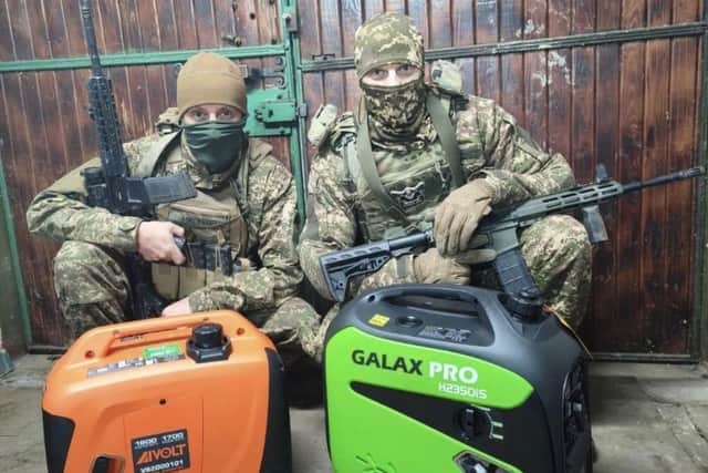 Ukrainian soldiers with generators Iain delivered on his first aid visit to the country