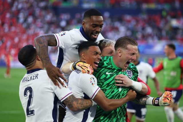 DUSSELDORF, GERMANY - JULY 06: Trent Alexander-Arnold of England celebrates scoring the team's fifth and winning penalty in the penalty shoot out with teammates Kyle Walker, Ivan Toney and Jordan Pickford during the UEFA EURO 2024 quarter-final match between England and Switzerland at Düsseldorf Arena on July 06, 2024 in Dusseldorf, Germany. (Photo by Dean Mouhtaropoulos/Getty Images)