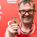 John Houghton with his medal after completing Sunday's TCS London Marathon in aid of the British Heart Foundation