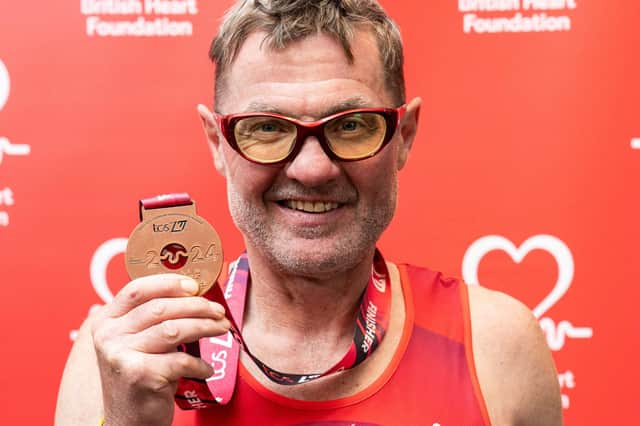 John Houghton with his medal after completing Sunday's TCS London Marathon in aid of the British Heart Foundation
