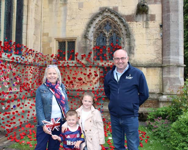 Amanda Fare and husband, Brian, with grandchildren, Annabelle and Reggie, next to the poppy display they helped create at St Mary's Church, in Melton