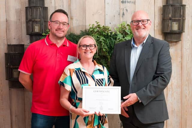 Stuart Maclean and Steph Newman receive a cheque for Melton Foxes Football Club