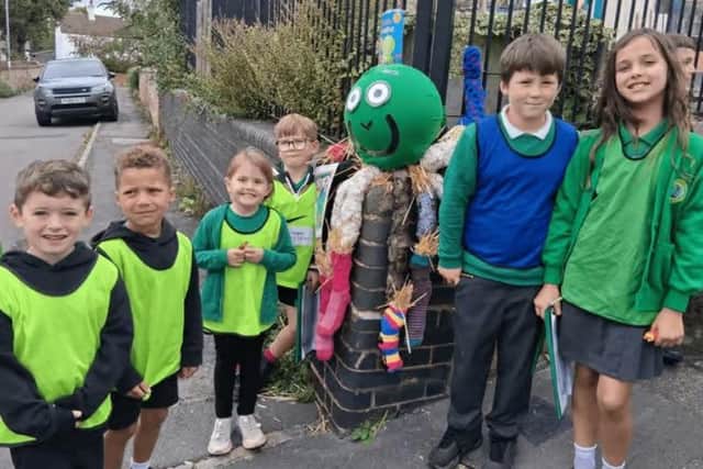 Frisby School students with one of the scarecrows in the festival